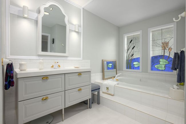 Bathroom with vanity, a bath, and tile patterned flooring | Image 18