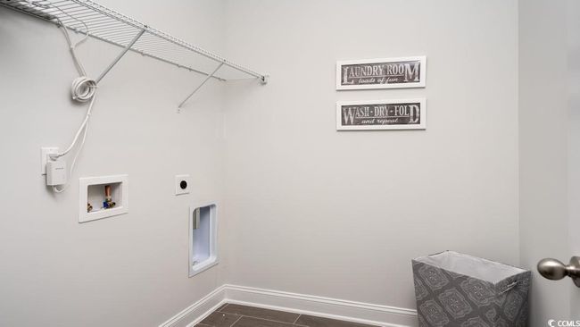 Laundry room featuring laundry area, baseboards, hookup for a washing machine, dark wood-style floors, and electric dryer hookup | Image 33