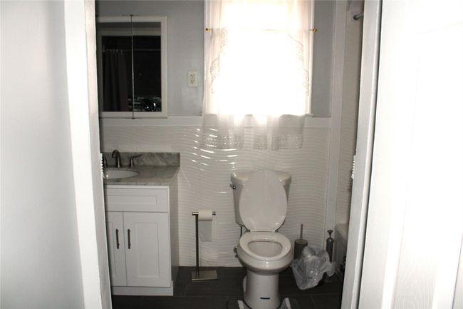 Bathroom featuring vanity, toilet, and tile patterned floors | Image 19