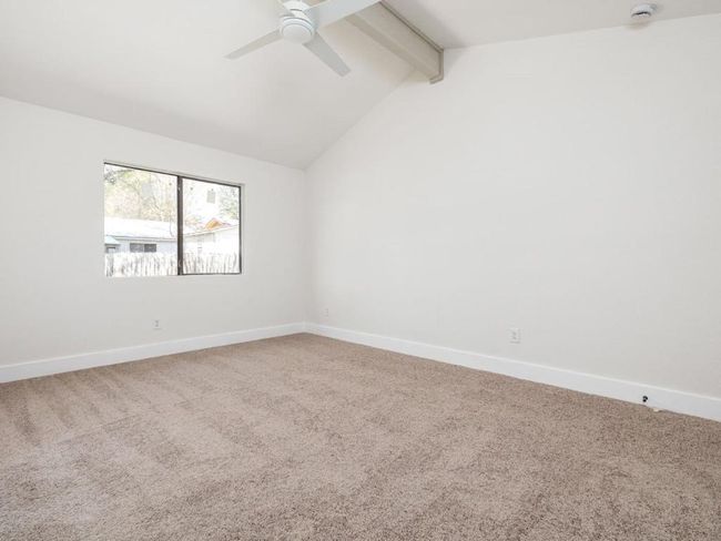 Unfurnished room featuring vaulted ceiling with beams, carpet, baseboards, and ceiling fan | Image 21