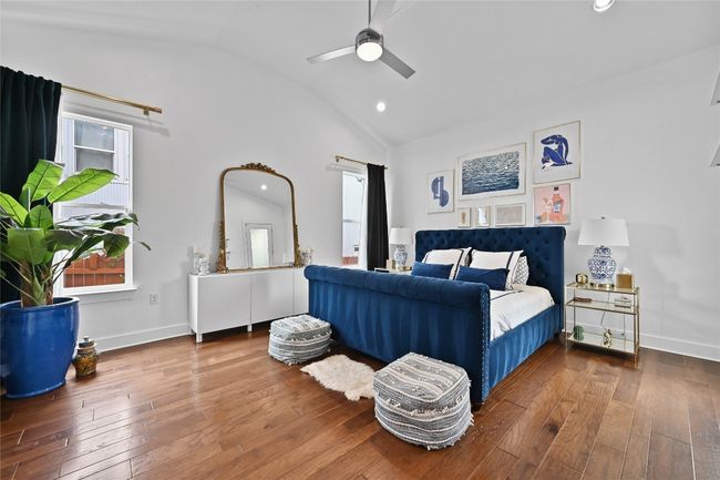 Bedroom with wood-type flooring, recessed lighting, ceiling fan, and high vaulted ceiling | Image 12