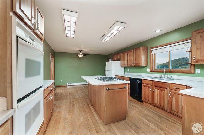 Kitchen island, cherry cabinrts and wood floors | Image 6