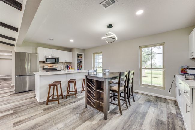 Dining area with light wood finished floors and recessed​​‌​​​​‌​​‌‌​‌‌​​​‌‌​​‌‌​‌​​​​​‌ lighting | Image 13
