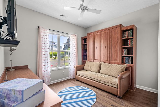Living area featuring baseboards, wood finished floors, ceiling fan, and a textured ceiling | Image 26