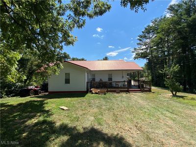 Rear view of house featuring a wooden deck and a yard | Image 3