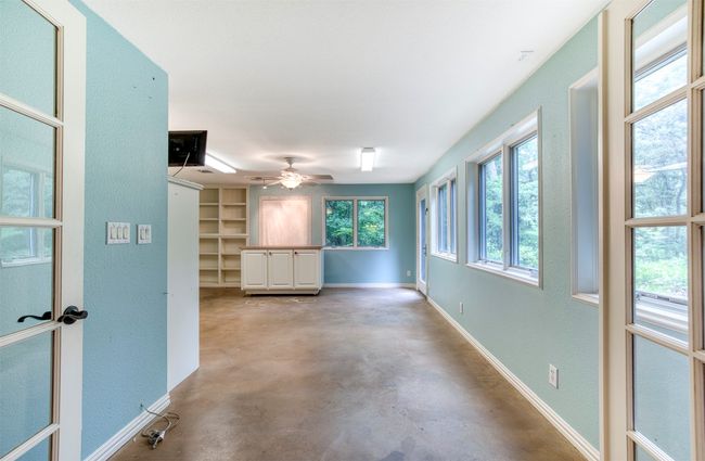Downstairs bonus room with built-ins and windows throughout. | Image 25