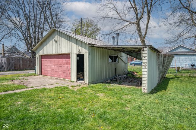 garage with a garage and fence | Image 22