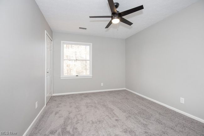 Empty room with light carpet and ceiling fan | Image 23