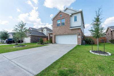 This 2 sotry home, built in 2021 has a modern facade and a well-maintained front yard. | Image 2