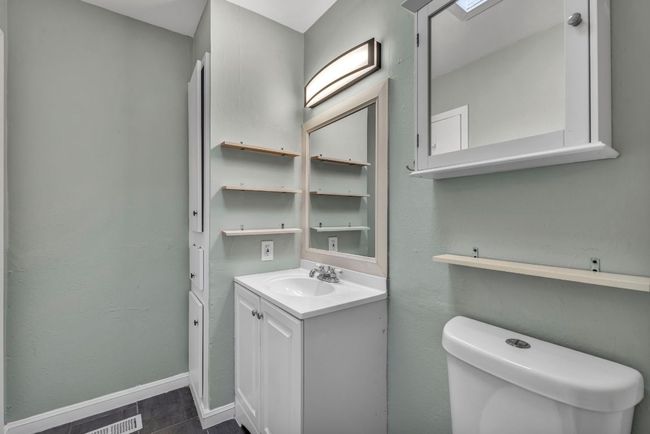 Half bath featuring toilet, vanity, and baseboards | Image 18