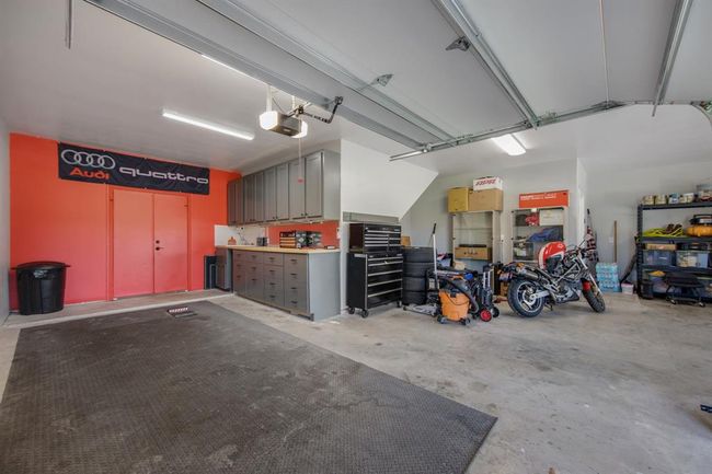 Third bay of garage features built-in cabinets, sink and double doors that lead to the back yard. Sellers added blown in insulation to the attic above the garage and added a mini-split a/c unit | Image 32