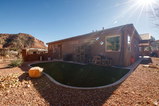Rear view of house with a tiled roof, a mountain view, fence, and central air condition unit | Image 38