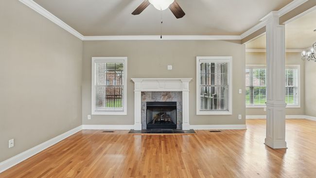 The living room features a remote-controlled gas fireplace, perfect for enjoying a cozy setting with friends & family. | Image 6