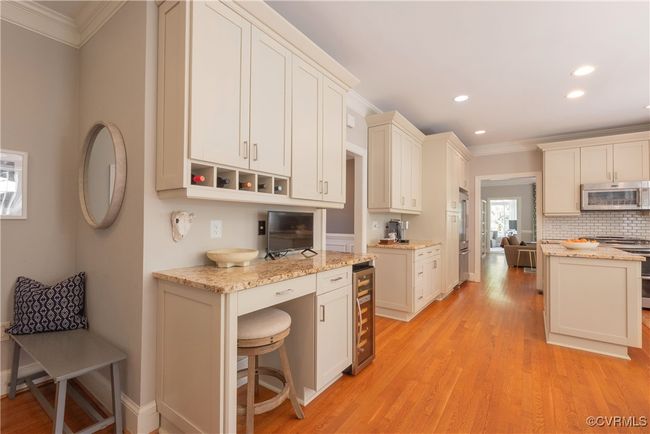 Kitchen with crown molding, appliances with stainless steel finishes, beverage cooler, and recessed lighting | Image 18