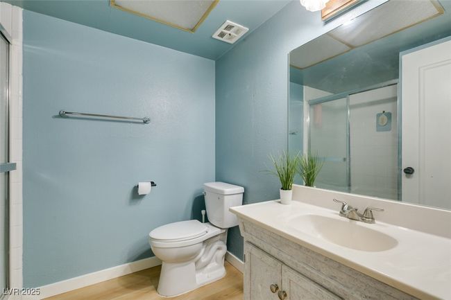 Bathroom with wood finished floors, vanity, and a shower with shower door | Image 29