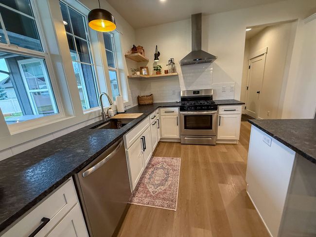 Kitchen featuring stainless steel appliances and gas range | Image 35