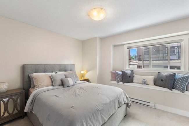 Carpeted bedroom with a baseboard heating unit | Image 13