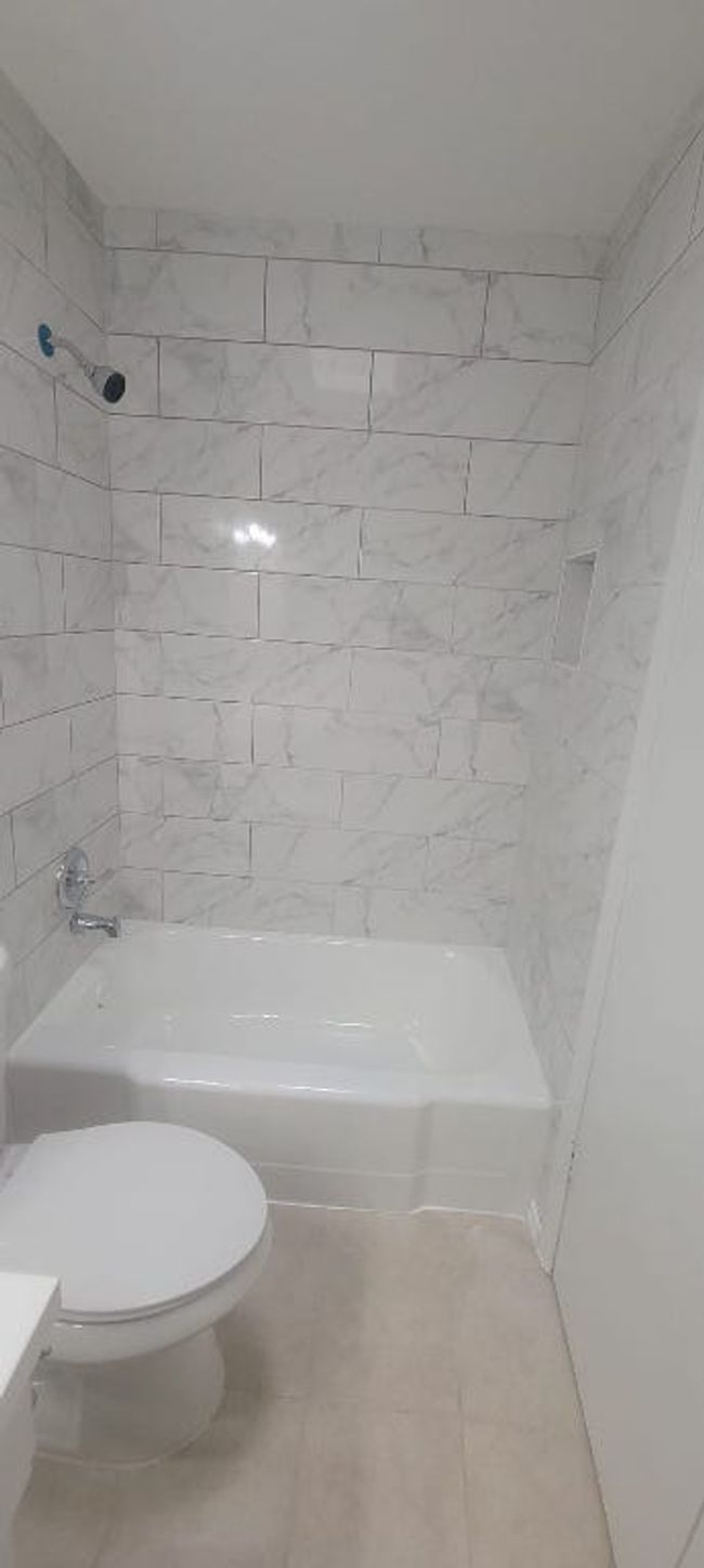 Full bath with tile patterned flooring and shower / bathtub combination | Image 13