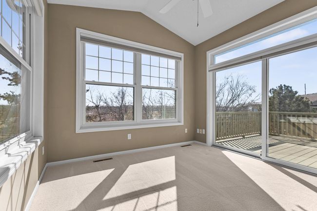 Sunroom has fabulous, vaulted ceilings, windows that allow the natural light to pour in, and wonderful views of the wetlands! New sliding door 2024. | Image 5