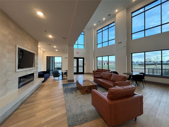 Living room featuring a water view, a fireplace, and light hardwood / wood-style floors | Image 4