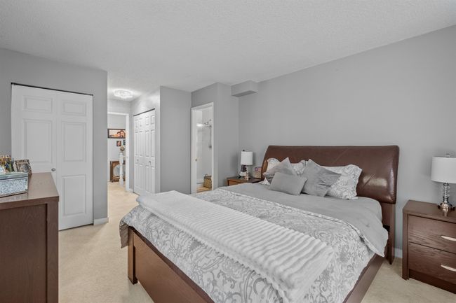 Bedroom with light carpet, a textured ceiling, and a closet | Image 7
