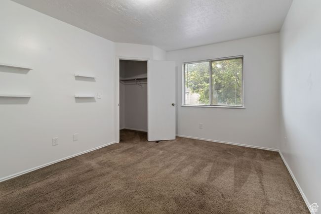 Unfurnished bedroom with carpet and a closet | Image 12