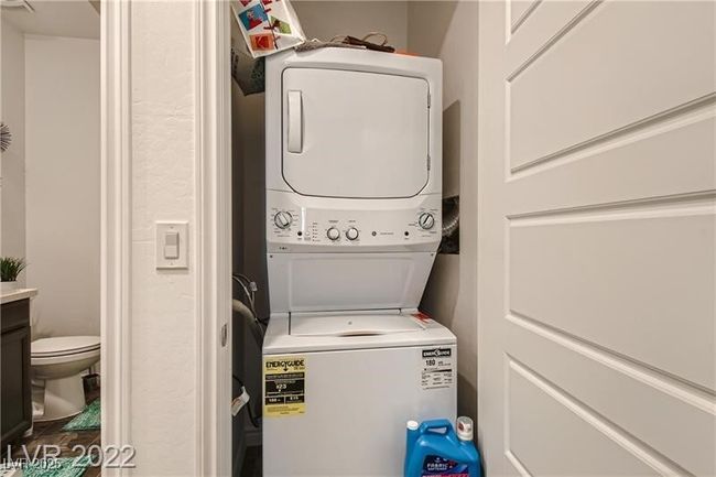 Clothes washing area with stacked washer and clothes dryer and laundry area | Image 20