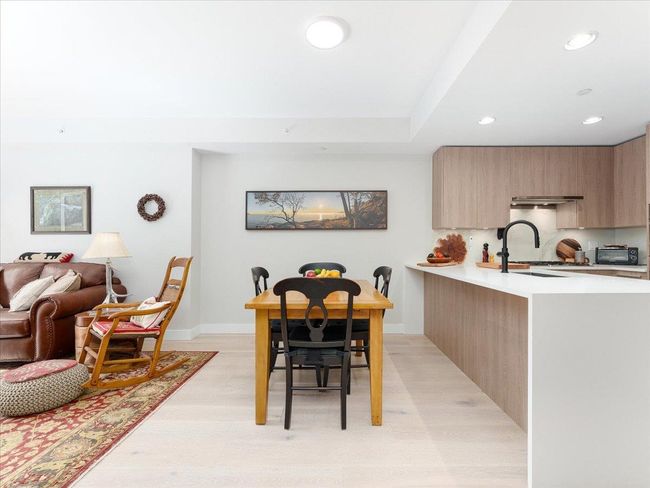 Dining area with light wood-style flooring and recessed lighting | Image 7