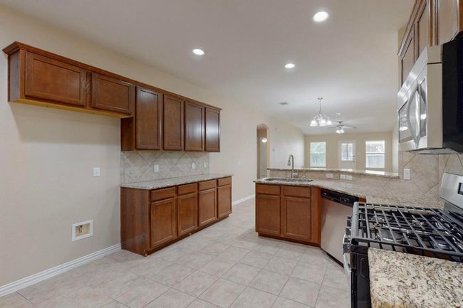 The cook is not isolated from the group. There is a breakfast bar on the opposite side of the sink. Family and friends love to gather in the kitchen, now they can have a set too! | Image 6
