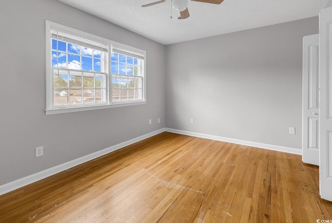 Unfurnished room featuring a ceiling fan and light wood finished floors | Image 23