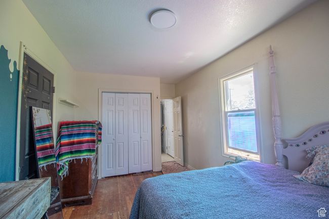Bedroom with wood finished floors and a closet | Image 11