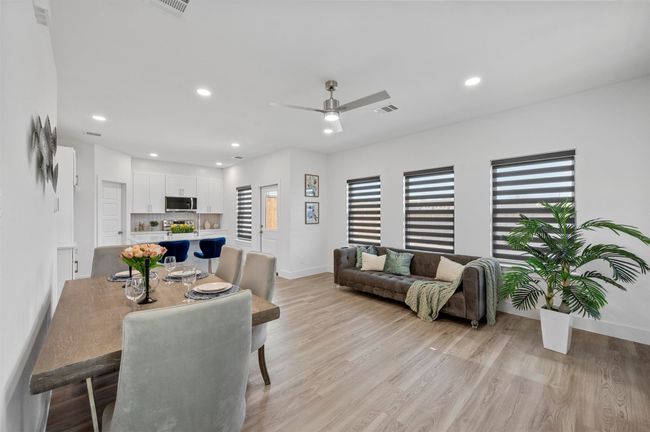 Dining area featuring light wood-style flooring, a ceiling fan, and recessed lighting | Image 5