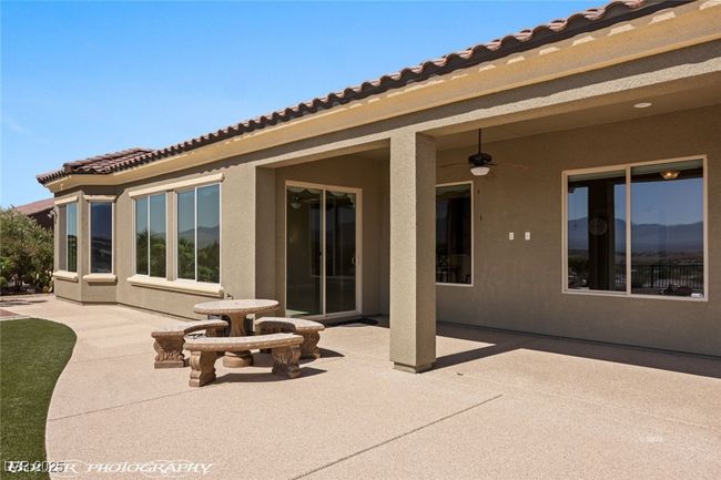 Rear view of house featuring a patio, stucco siding, and ceiling fan | Image 55