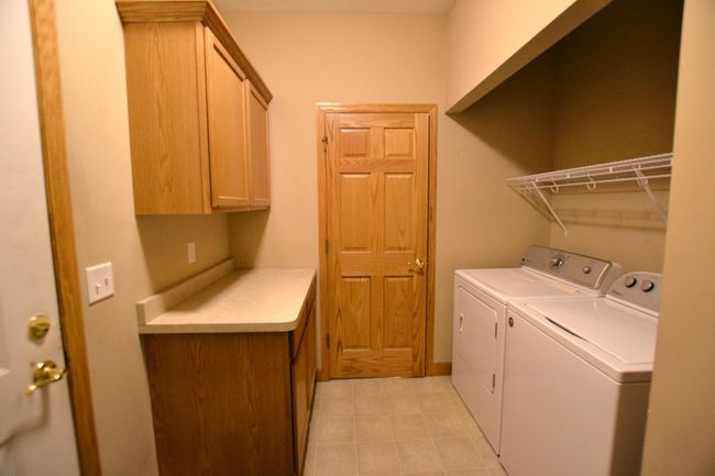 Main floor laundry with storage & counter space! | Image 13
