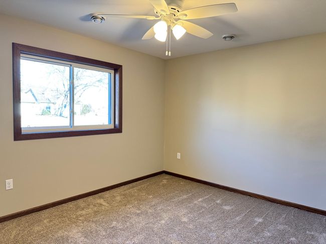 Bedrooms feature plush carpeting & ceiling fans. | Image 12