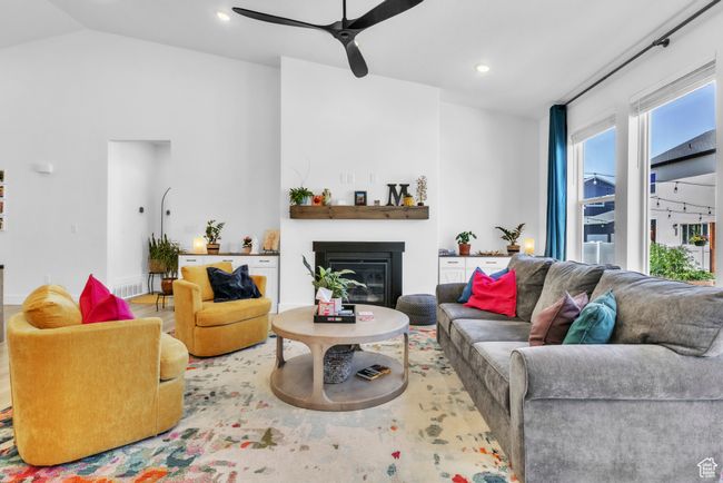 Living area with ceiling fan, a glass covered fireplace, recessed lighting, and vaulted ceiling | Image 8