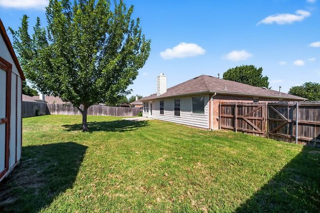 View of fenced backyard | Image 37