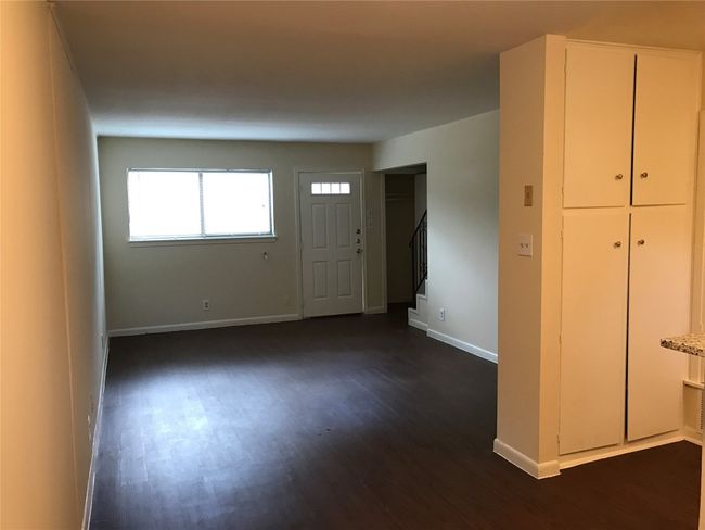 Entrance foyer featuring stairs, baseboards, and dark wood-type flooring | Image 14