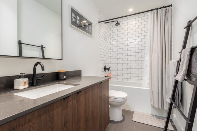 Bathroom with vanity, shower / tub combo with curtain, and tile patterned flooring | Image 18