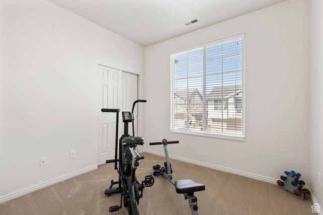 Workout area featuring visible vents, baseboards, and carpet | Image 11