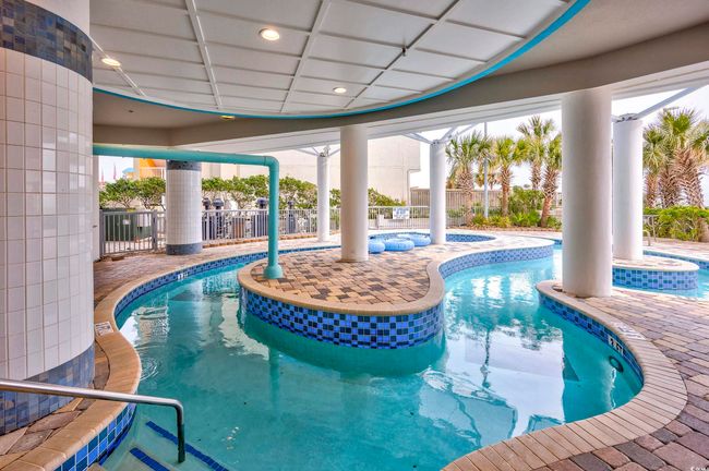Community pool with a jacuzzi, a patio area, and fence | Image 29
