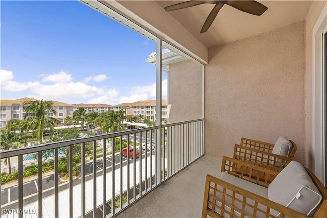 Balcony with a residential view and a ceiling fan | Image 19