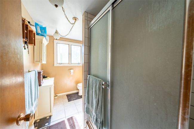 Full bath featuring vanity, a shower stall, and tile patterned floors | Image 45