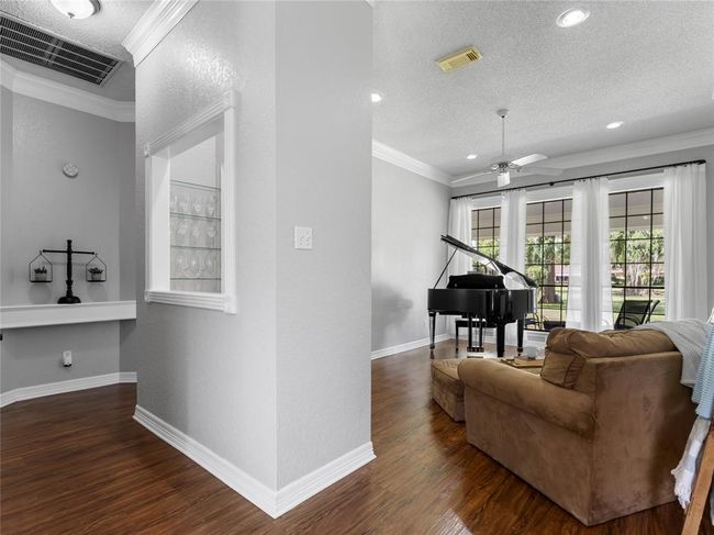 Hallway to half bath and primary bed and bath | Image 9