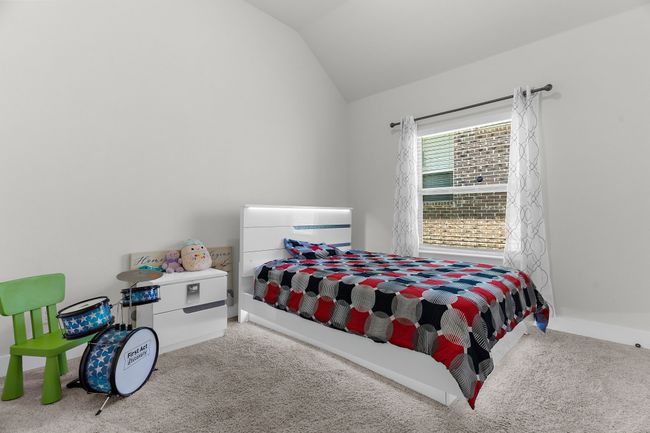 Carpeted bedroom featuring lofted ceiling and baseboards | Image 23
