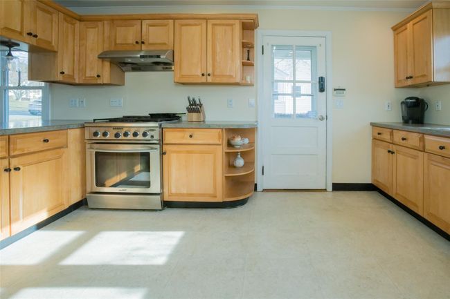 Kitchen featuring crown molding and high end stainless steel range | Image 9