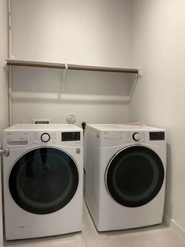 Laundry room featuring washing machine and clothes dryer | Image 24