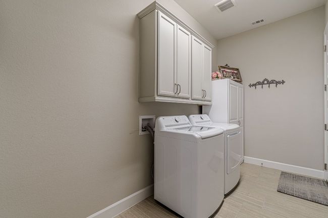 Washroom with cabinet space, independent washer and dryer, and baseboards | Image 24