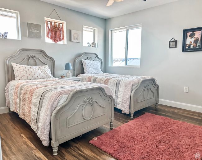 Bedroom with baseboards, a ceiling fan, and dark wood finished floors | Image 23