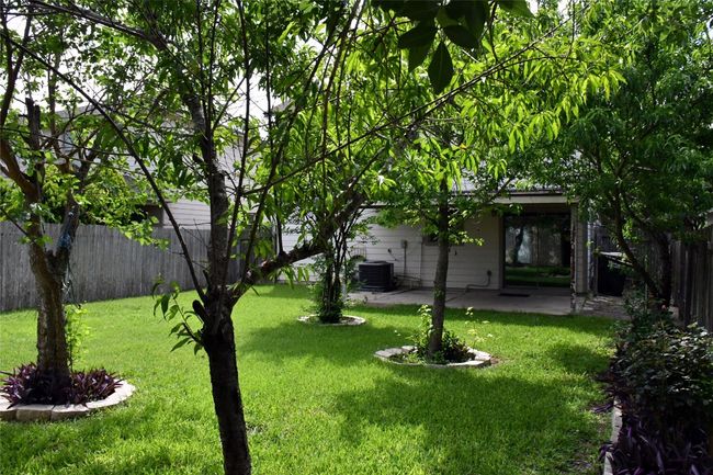 View of yard with a patio area, a fenced backyard, and cooling unit | Image 32